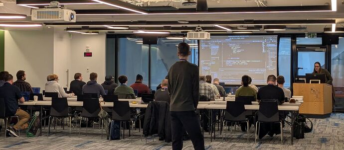 Attendees watching the very first workshop, "Markov Chain with a Shotgun: Open Language Models in Godot", on the first day of the convention.